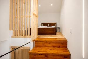 a staircase with a bed in a room at Oasis Acropolis Serres Parking EV Next to Center in Serres +41 photos