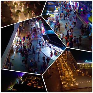 a group of people walking around a shopping mall at Sea View Smart Choice in Costinesti