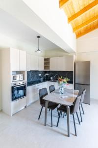 a kitchen and dining room with a table and chairs at Tsoutsis Villas in Marantochori
