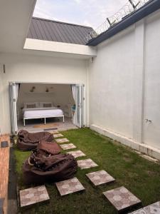 a backyard with a bed of blankets on the grass at Rumah Kodel2 in Bukit Lawang