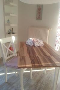 a wooden table with two pillows on top of it at Apartment Florö by Interhome in Putbus