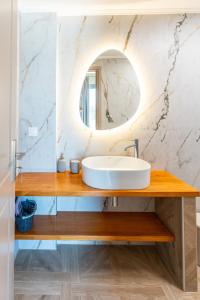 a bathroom with a sink and a mirror at Tsoutsis Villas in Marantochori +78 photos