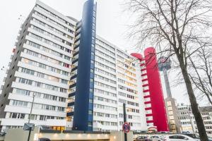 a large building with cars parked in front of it at Messeapartment Köln in Cologne