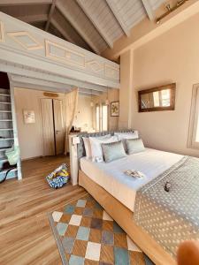 a bedroom with a large bed in a room at Symi Aerides Suites in Symi