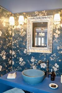 a bathroom with a blue sink and a mirror at Symi Aerides Suites in Symi +43 photos