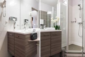 a bathroom with two sinks and a shower at Carré Py' Hôtel in Bagnères-de-Bigorre