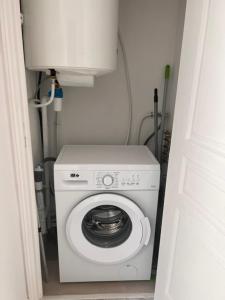 a white washer and dryer in a small room at Eymet Holiday Rentals in Eymet