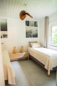 a bedroom with two beds and a window at Nedecvidék ház in Isztimér