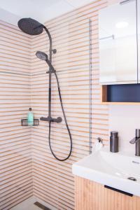 a shower in a bathroom with a sink at Nedecvidék ház in Isztimér +32 photos