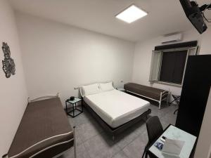 a bedroom with a bed and a table and chairs at Grenada Home in Praia a Mare