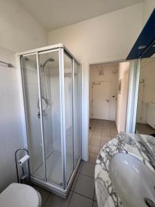 a bathroom with a shower and a sink and a toilet at Lago Blu in Riva del Garda +7 photos