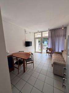 a living room with a table and a couch at Lago Blu in Riva del Garda