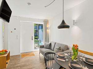 a living room with a table and a couch at Apartment Seewind by Interhome in Lembruch +24 photos