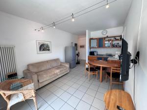 a living room with a couch and a table at Lago Blu in Riva del Garda