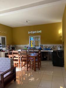 a kitchen and dining room with a table and chairs at Villa Donia Nosy be in Nosy Be