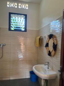 a bathroom with a sink and a window at Villa Donia Nosy be in Nosy Be