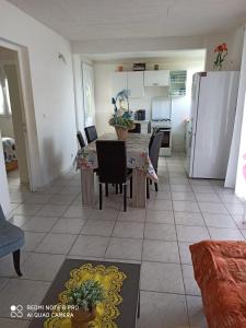 a kitchen and dining room with a table and chairs at F2 F3 Marjo tranquillity in Le Carbet