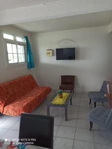 a living room with a couch and a table at F2 F3 Marjo tranquillity in Le Carbet