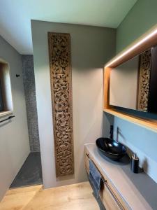 a bathroom with a sink and a mirror on a wall at Ascona Casa Mamina A in Ascona