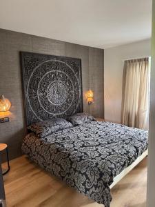 a bedroom with a bed with a decorative headboard at Ascona Casa Mamina A in Ascona