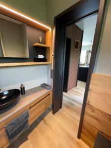 a bathroom with a mirror and a sink in a room at Ascona Casa Mamina A in Ascona