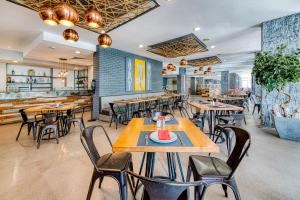 a restaurant with tables and chairs and a bar at Gladiola 4-star in Golden Sands