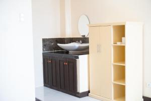 a bathroom with a sink and a mirror at Balud White Beach Resort in Moalboal