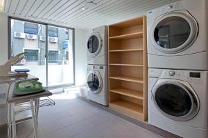 a laundry room with two washer and dryer at Park City Hotel Central Taichung in Taichung