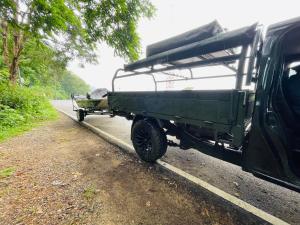a green wagon parked on the side of a road at Forest Fishing in Ban Pa Kluai