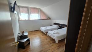 a small room with two beds and a window at Casa Cristal in Eforie Sud