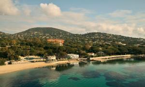 a view of a beach and a body of water at COMO Le Beauvallon - Golfe de Saint-Tropez in Grimaud