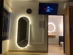 a hallway with a mirror and a clock on the wall at Hostal Monte Verde in Zaragoza