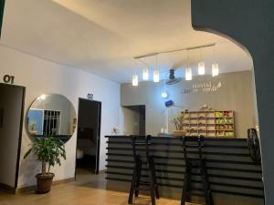 a restaurant with a bar with stools in a room at Hostal Monte Verde in Zaragoza