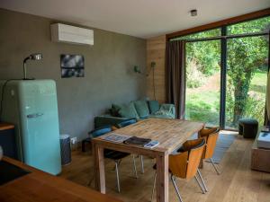 a living room with a table and a couch at Chez Oreste - Escapade à 2 avec sauna et jardin clos in Aywaille +19 photos