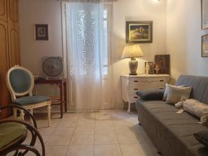a living room with a couch and a window at Sophisticated Central House Tinos in Tinos +91 photos