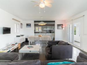 a living room with a couch and a table at Villa Sa Blanca by Interhome in Es Mercadal +28 photos