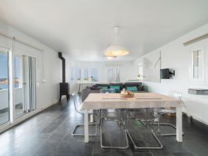 a living room with a table and a couch at Villa Sa Blanca by Interhome in Es Mercadal