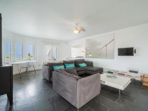 a living room with a couch and a table at Villa Sa Blanca by Interhome in Es Mercadal