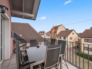 a balcony with chairs and a table on a building at Apartment Nina - 9 by Interhome in Endingen