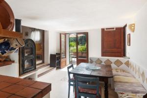 a kitchen with a table and a dining room at Can Carabá in Illes Balears