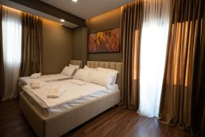 a bedroom with a large white bed and a window at 2S Vila Boutique Pogradec in Pogradec