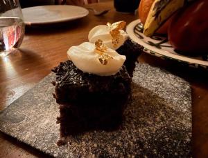 a piece of chocolate cake with cream on a table at Sahara Gift camp in Merzouga +65 photos