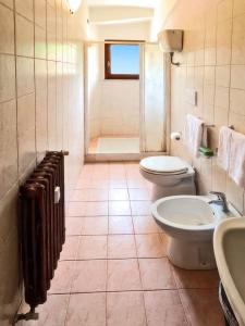 a bathroom with a toilet and a sink and a shower at Hotel Residence Sant'Uberto in Roccastrada +17 photos