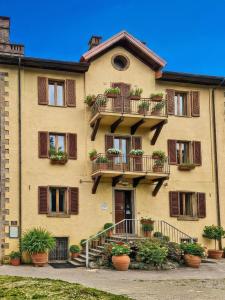 a building with potted plants in front of it at Hotel Residence Sant'Uberto in Roccastrada