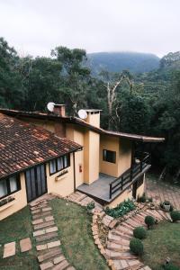 a house with a deck and a view of the mountains at Villa di Serra by Concavus in Monte Verde