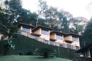 a large house with a fence in front of it at Villa di Serra by Concavus in Monte Verde