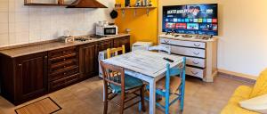 a kitchen with a table and chairs in a kitchen at Hotel Residence Sant'Uberto in Roccastrada