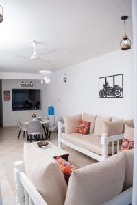 a living room with two couches and a table at Vista del mar homes in Malindi +9 photos