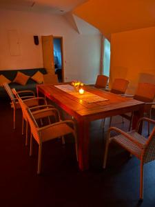 a dining room with a wooden table and chairs at Balat-ON Apartman in Balatonberény +38 photos