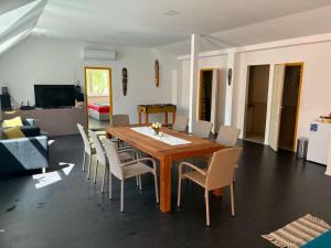 a dining room with a wooden table and chairs at Balat-ON Apartman in Balatonberény